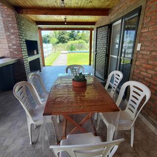 Galería cubierta con mesa y parrillero